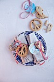Peace-symbol biscuits and tags made from maps