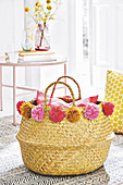A basket decorated with homemade pompoms