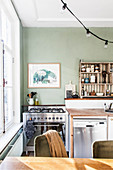 Green wall, gas cooker and vintage fridge in kitchen