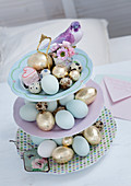 Easter eggs and bird figurine on cake stand