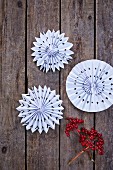 White paper rosettes on rustic wooden boards