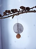 Paper and cork bed pendant hung from larch branch