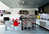 Designer chairs in kitchen and dining area of industrial loft apartment