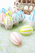 White Easter eggs with decorated colourful stripes