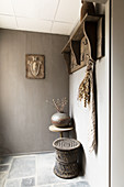 Coat rack in elegant, rustic foyer in shades of grey
