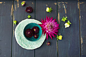 Dahlias in bowl and on wooden surface
