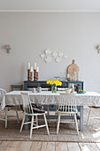 Crumpled tablecloth on table in front of pale grey wall