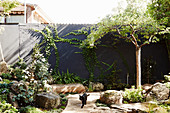 Rock garden with black privacy wall