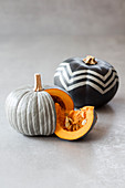 Pumpkins painted grey with white zigzags and stripes