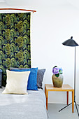 Fabric with exotic pattern of leaves used as bed headboard