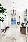 Elegant entrance hall with benches, console table and artwork