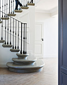 Classic foyer with elegant staircase and panelled walls