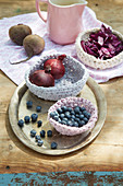 Blueberries and red onions in hand-crocheted basket made from dyed fabric strips