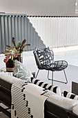 Black and white patterned textiles on sofa and armchair on terrace