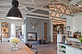 Kitchen and dining area in open-plan interior of converted stable