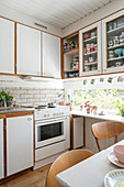 Ribbon window in cosy, white kitchen-dining room