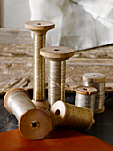 Silver thread on old wooden spools