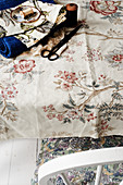 Sewing utensils on floral tablecloth