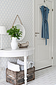 Semicircular console table against wall with diamond-patterned wallpaper