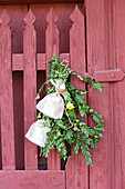 Door decoration made from box twigs and cloth sachets with bunny motifs