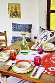 Table set with colourful crockery