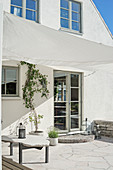 Terrace with awning outside gabled house