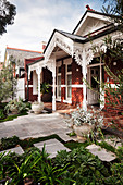 Victorian brick house with lush decorative elements