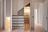 Walk-in wardrobes with open doors and lighting