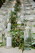 Festively decorated table with lanterns and flower garland