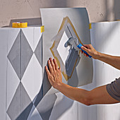 Applying a diamond pattern to board wall using a template