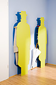 Colourful cloakroom stands in the shape of a man wearing a hat