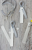 Making festive name tags from strips of paper and gingham ribbon