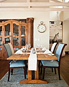 Set, rustic wooden table and upholstered chairs in dining area