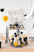 Space party: cake pops on table festively set for child's birthday party