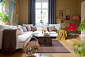 Vintage-style wallpaper and flea-market finds in living room