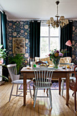 Various old furnishings and blue wallpaper in dining room
