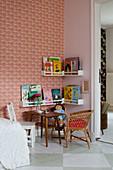 Shelves of books in reading corner of child's bedroom with retro wallpaper