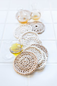 Facial cleansing pads hand-crocheted from white cotton yarn
