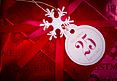 Christmas present wrapped in red paper with tag
