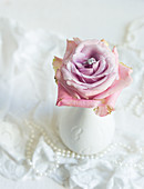 Romantic wedding decoration: ring nestled in a rose