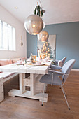 Spherical silver lamps above festively set dining table