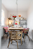 Festively set dining table in narrow room