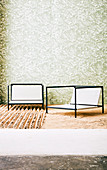 Outdoor chairs in front of wallpapered wall