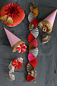 Christmas decorations hand-made from pink, red and gold paper
