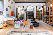 Three large, open terrace doors in artistic living room