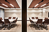 Eleganter Konferenzraum mit zwei Tischen und rollbaren Stühlen in Brauntönen