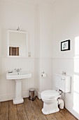 Vintage toilet and sink in minimalist bathroom