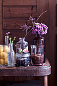 Fruit, chutneys and flowers in glass jars and vases