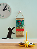Decorative cat scratching board made from plank, wool and fabric remnants