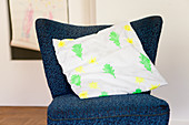 Cushion cover printed with yellow flowers and green leaves (DIY foam rubber stamp)